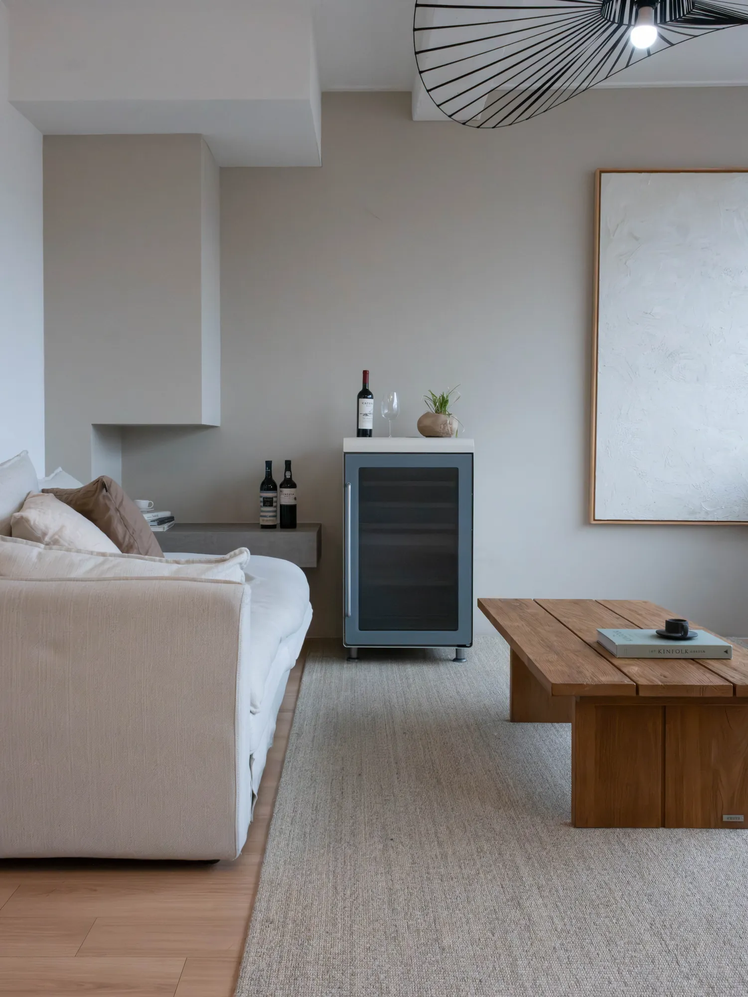 Wine cellar beside a wooden table and sofa