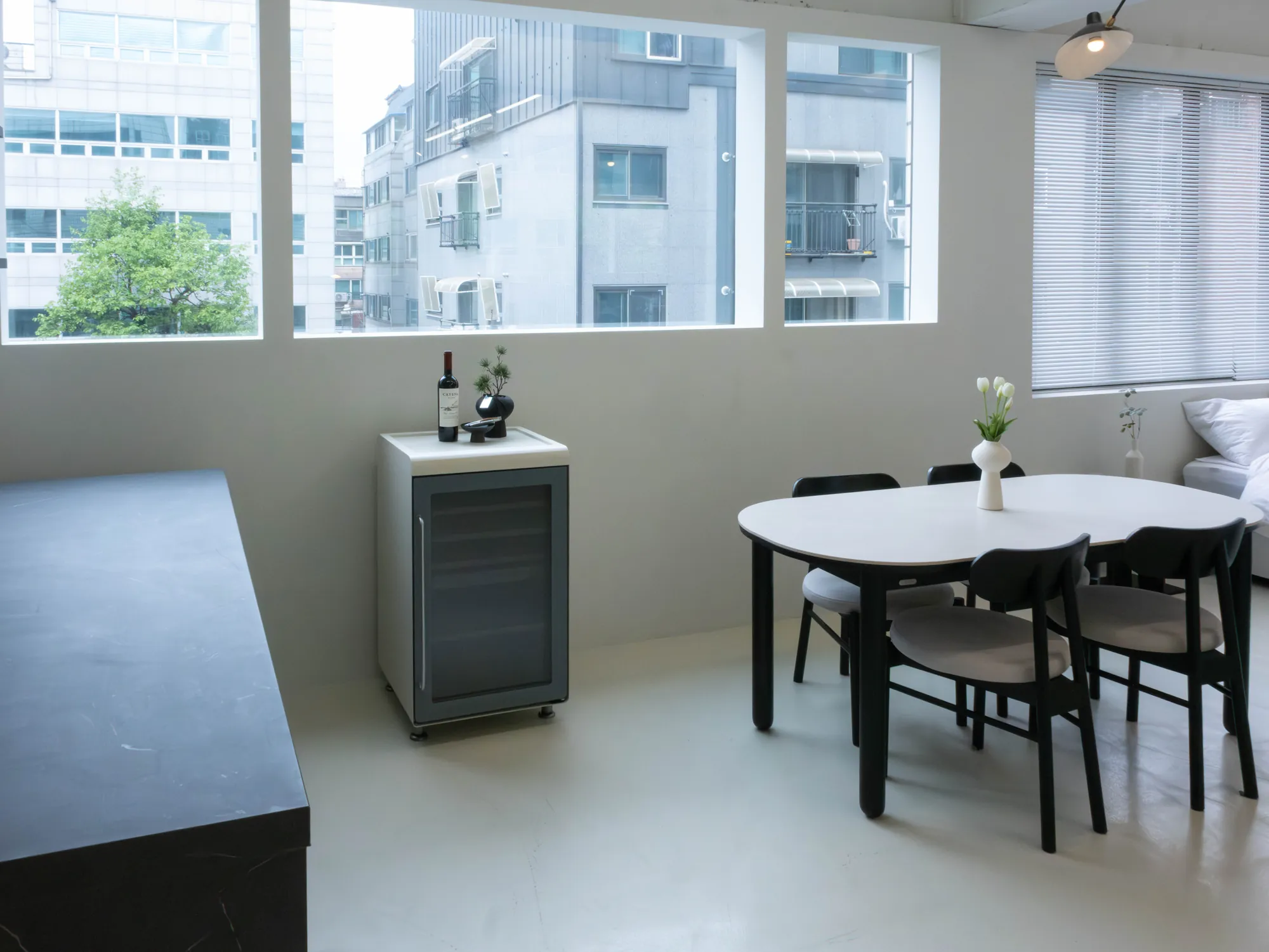 Wine cellar beside a dining table by the window