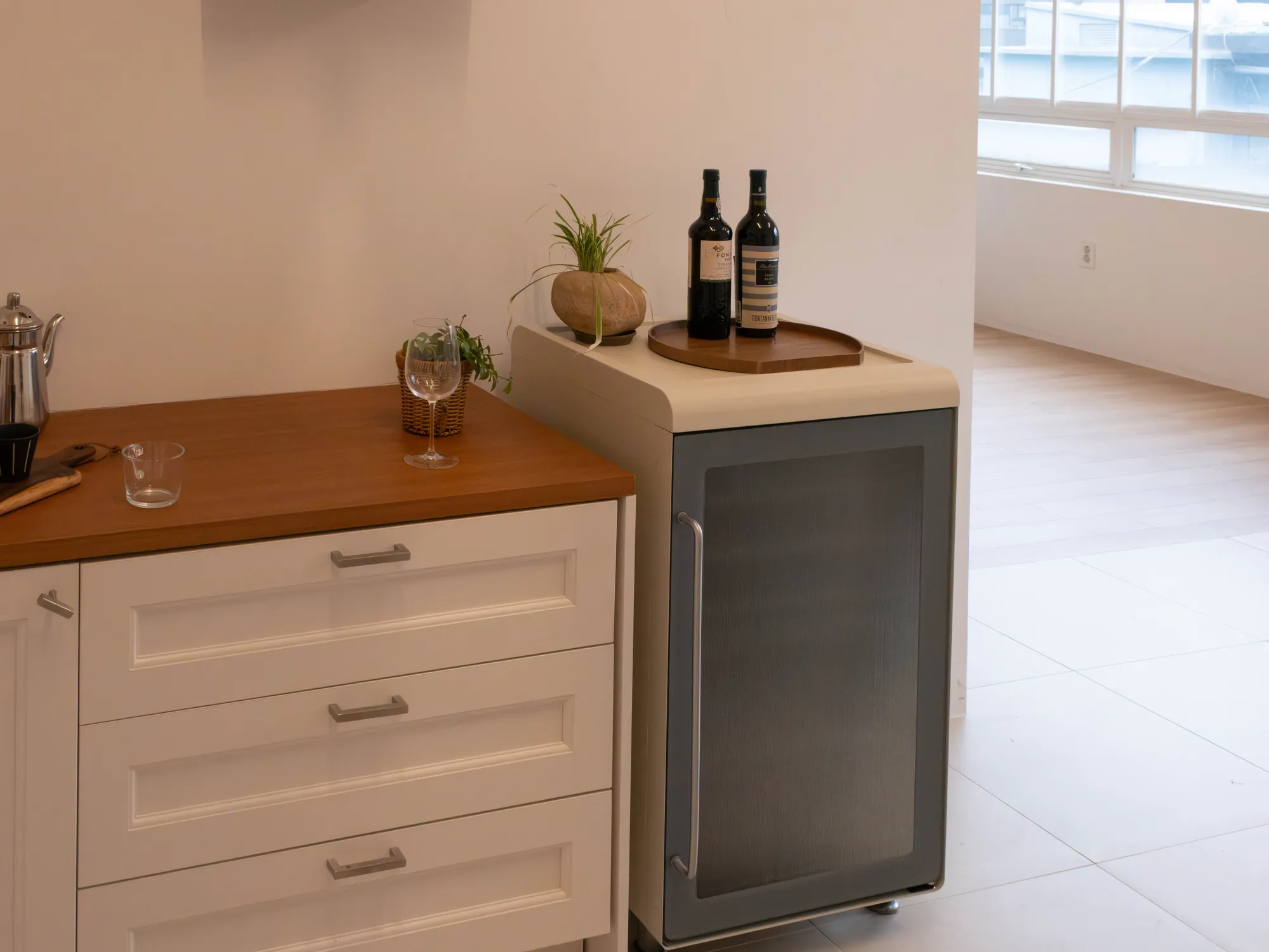 Wine cellar beside a kitchen counter